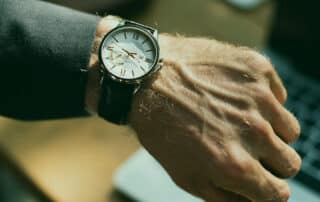 man looking at wristwatch