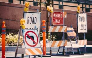 Road signs reading "road closed" and "wrong way" in Los Angeles.