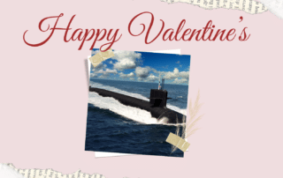 A picture of a Columbia Class Submarine areound a pink frame lined with hearts and large scripted text reading "Happy Valentine's Day"